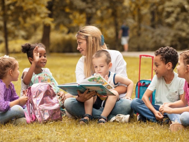 children reading outside