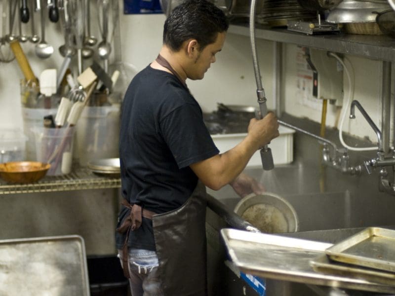 man washing dishes